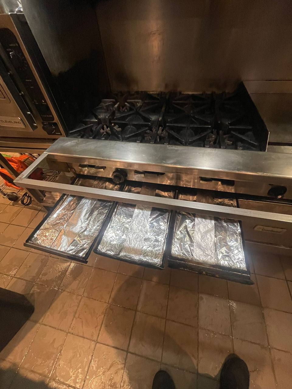 Commercial range and burners deep cleaned with fresh drip trays